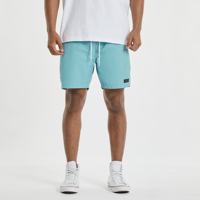 Model wears Sunrise Beach Short Turquoise Shorts in Blue - Image 1
