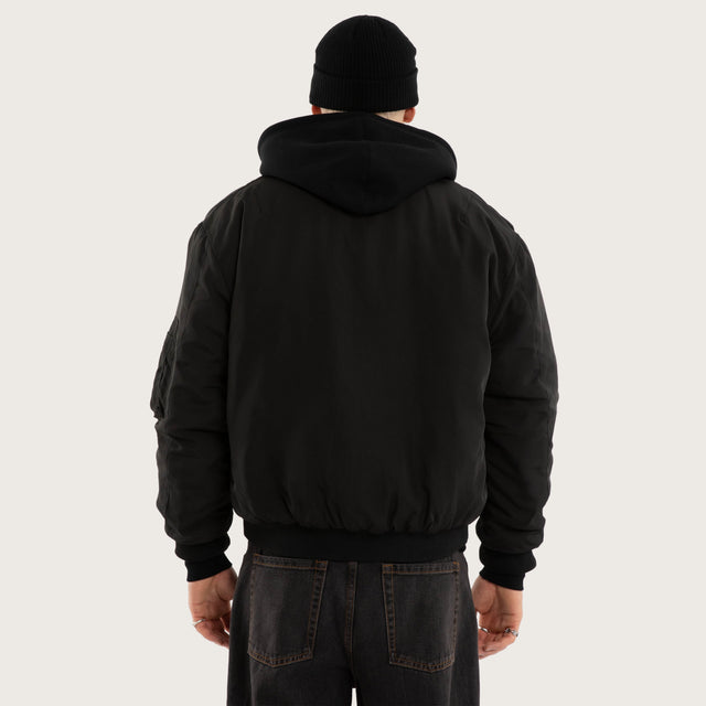 Model wears Realm Bomber Jacket Jet Black Jackets in Black - Image 3