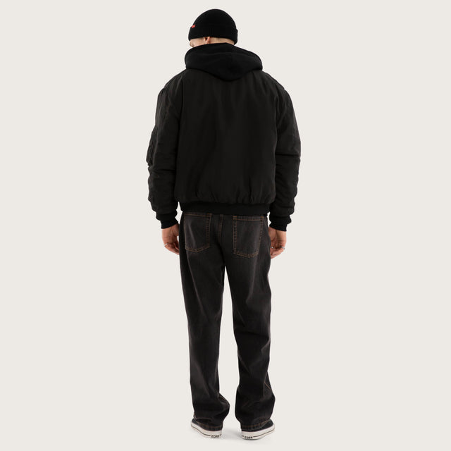 Model wears Realm Bomber Jacket Jet Black Jackets in Black - Image 4