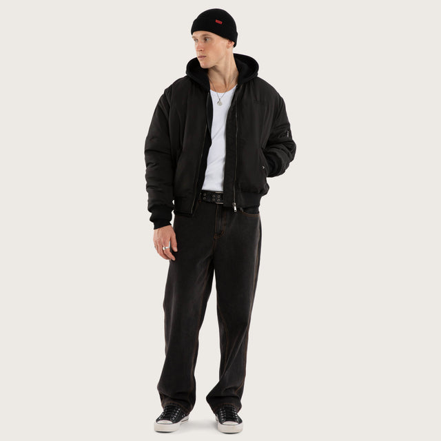 Model wears Realm Bomber Jacket Jet Black Jackets in Black - Image 5
