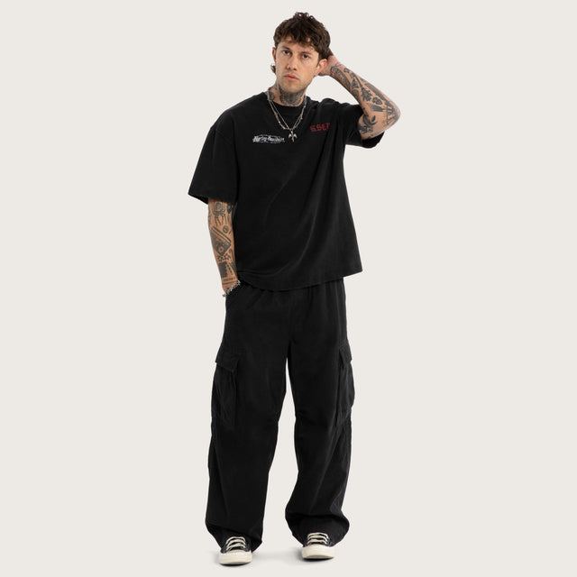 Model wears Instake Street Tee Snow Black T-Shirts Black – image 5