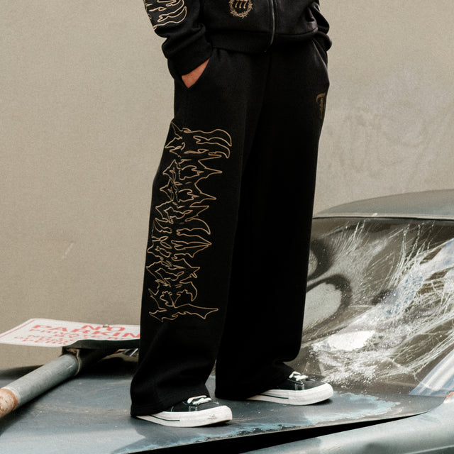 Model wears Wraith Baggy Sweatpant Jet Black Trackpants in Black - Image 5