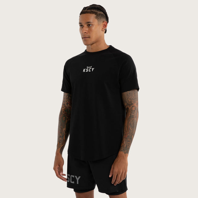 Model wears Vital Raglan Dual Curve Tee in Black | Kiss Chacey Activewear T-Shirts in Black - Image 3