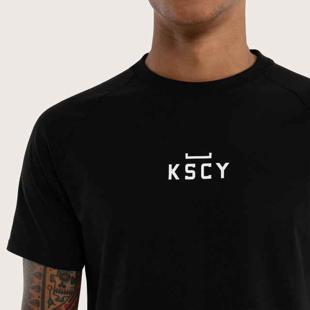 Model wears Vital Raglan Dual Curve Tee in Black | Kiss Chacey Activewear T-Shirts in Black - Image 4