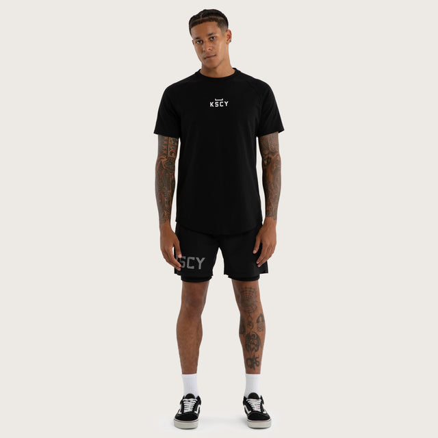 Model wears Vital Raglan Dual Curve Tee in Black | Kiss Chacey Activewear T-Shirts in Black - Image 5