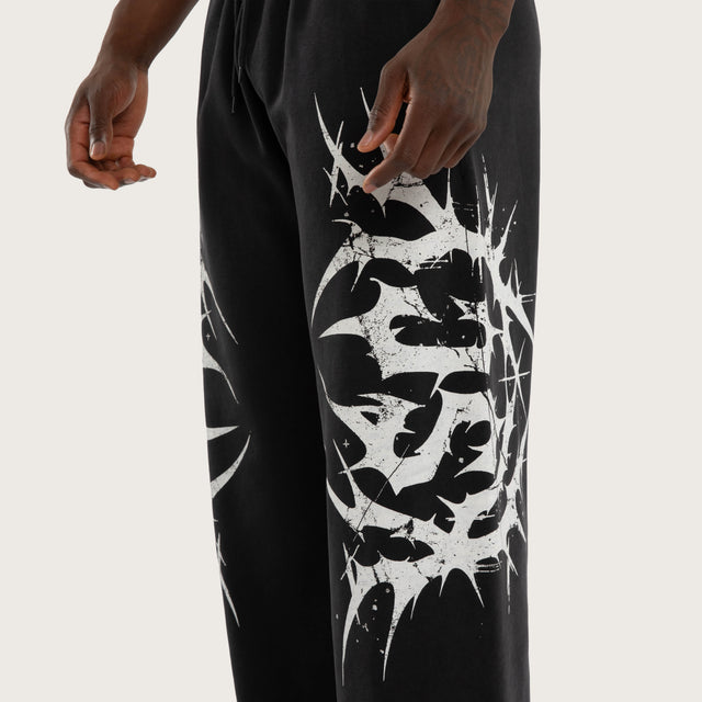 Model wears Chaotic Baggy Trackpant Black Trackpants Black – image 5