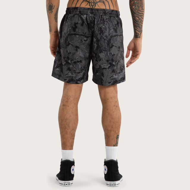 Model wears Chaos Rage Mesh Trackshort Dark Camo Activewear Trackpants in Camo - Image 4