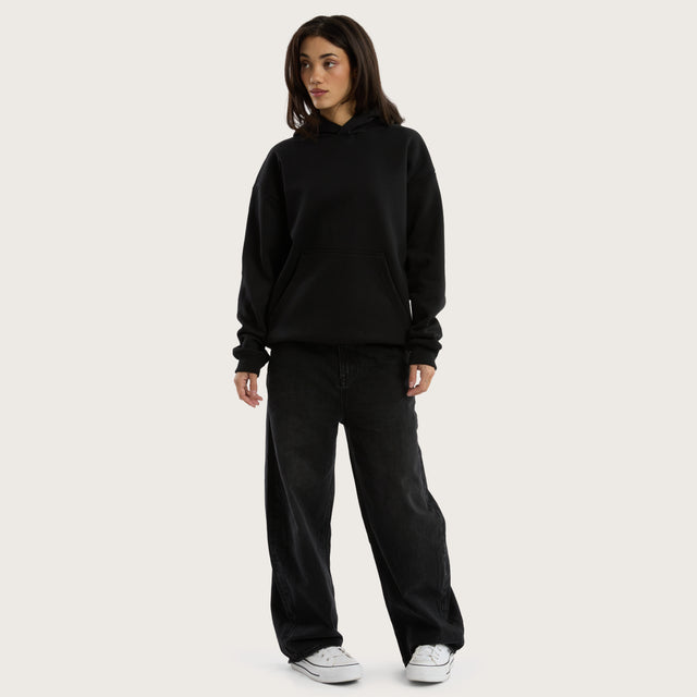 Model wears Weyburn Relaxed Hoodie Jet Black Hoodies in Black - Image 7
