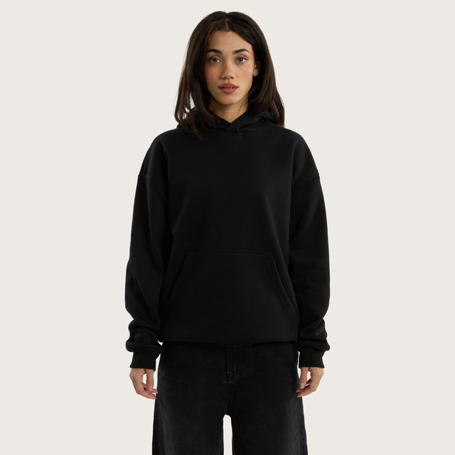 Model wears Weyburn Relaxed Hoodie Jet Black Hoodies in Black - Image 5
