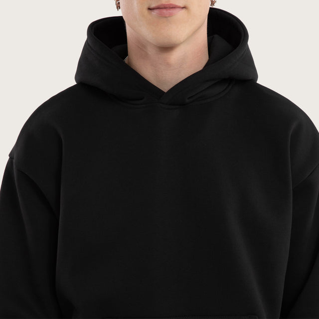 Model wears Weyburn Relaxed Hoodie Jet Black Hoodies in Black - Image 3