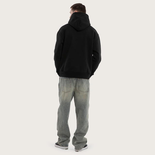 Model wears Weyburn Relaxed Hoodie Jet Black Hoodies in Black - Image 6