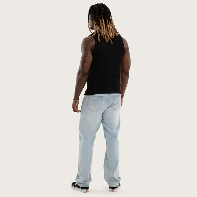 Model wears Weiza Waffle Cotton Singlet in Jet Black Tanks in Black - Image 4