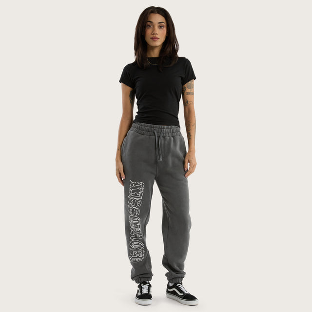 Model wears Genesis Trackpant Pigment Charcoal Trackpants in Grey - Image 4