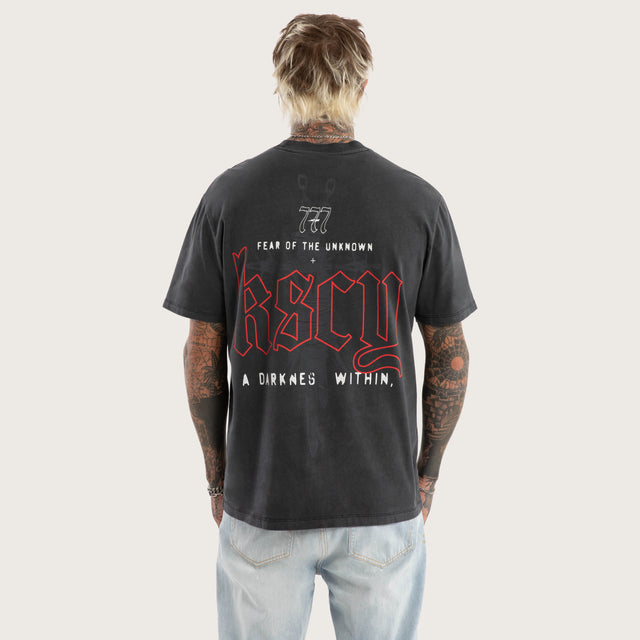 Model wears Within Relaxed Fit Tee in Black T-Shirts in Black - Image 1