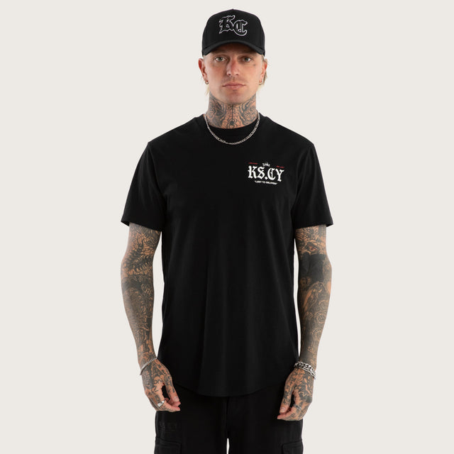 Model wears England Curved Hem Tee Jet Black T-Shirts in Black - Image 3