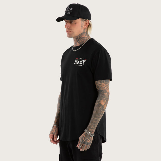 Model wears England Curved Hem Tee Jet Black T-Shirts in Black - Image 4