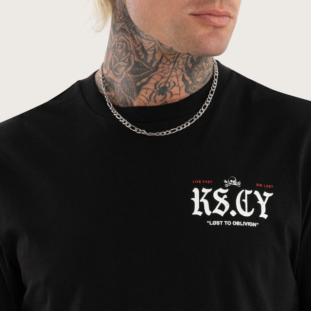 Model wears England Curved Hem Tee Jet Black T-Shirts in Black - Image 6