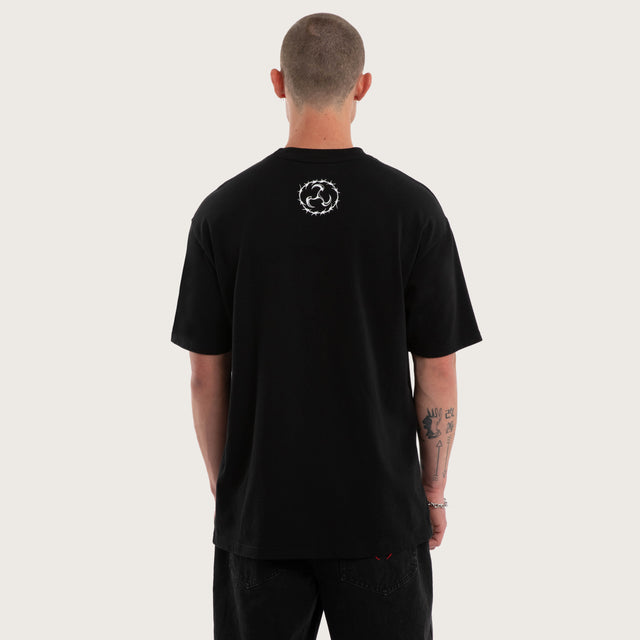 Model wears Utopia Box Fit Tee Jet Black T-Shirts in Black - Image 3