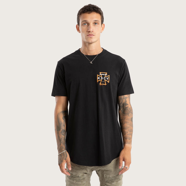 Model wears Retribution Curved Hem Tee Jet Black T-Shirts in Black - Image 1