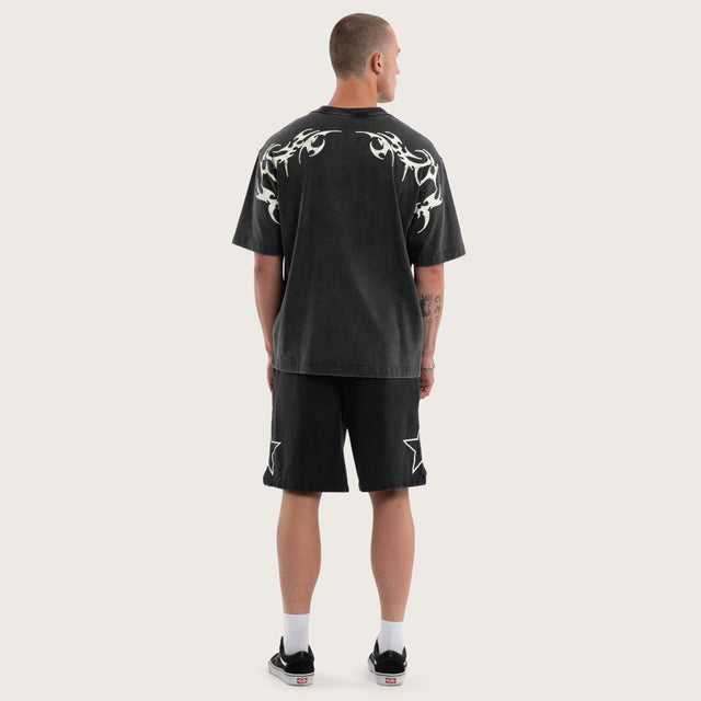 Model wears Cagey Oversized Tee Mineral Black T-Shirts in Black - Image 4