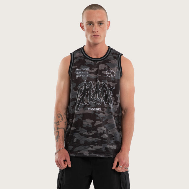 Model wears Glory Basketball Jersey Black Camo Jerseys in Camo - Image 1