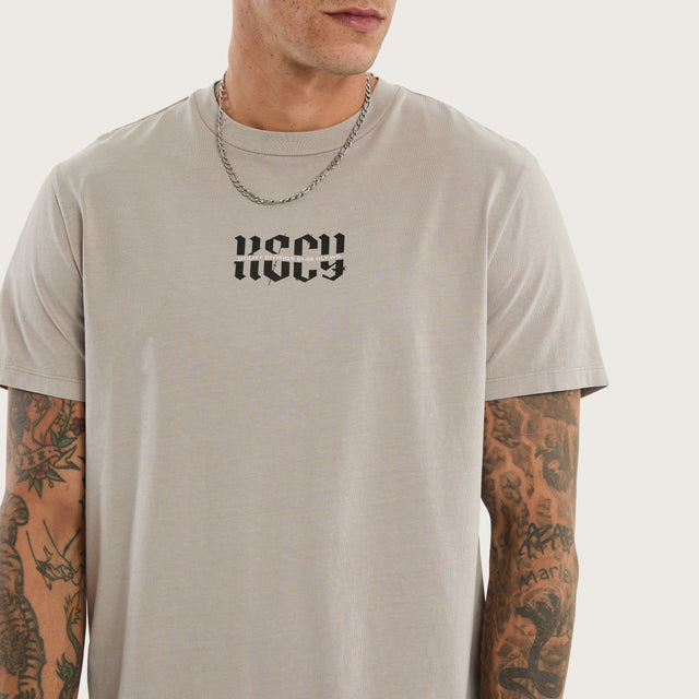 Model wears Sacred Dual Curved Tee Pigment Silver Cloud T-Shirts Grey – image 4