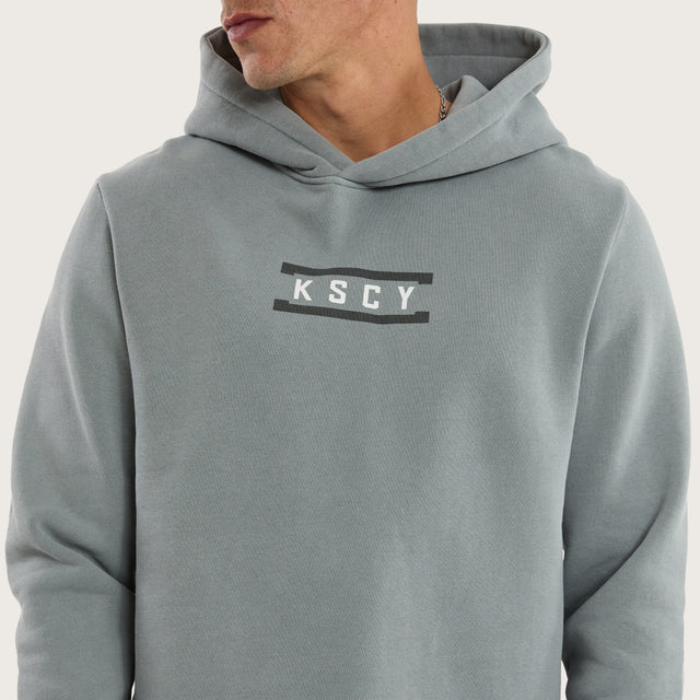 Model wears Divine Curved Hem Hoodie Pigment in Grey Hoodies in Grey - Image 3