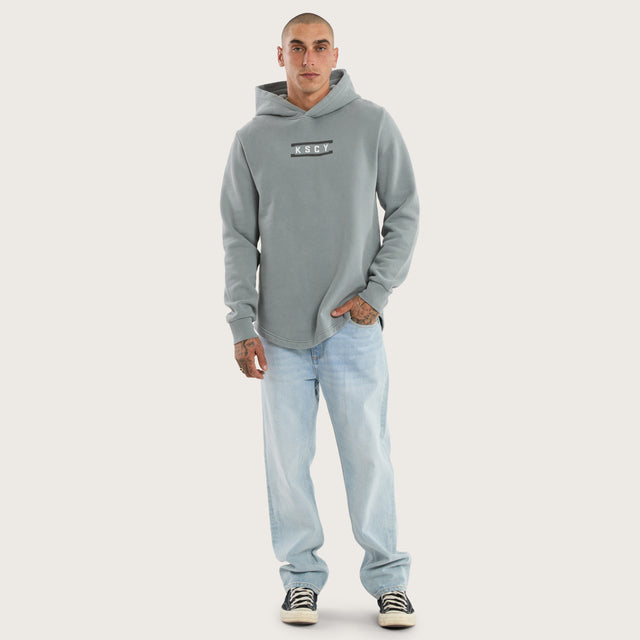 Model wears Divine Curved Hem Hoodie Pigment in Grey Hoodies in Grey - Image 5