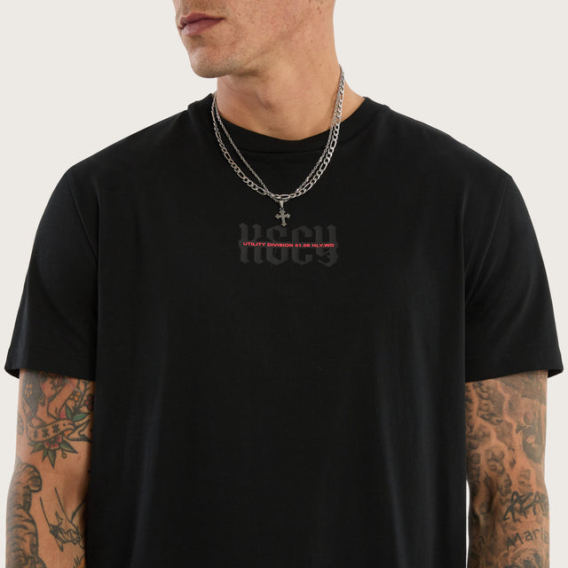 Model wears Apparition Curved Hem Tee Jet Black T-Shirts in Black - Image 4