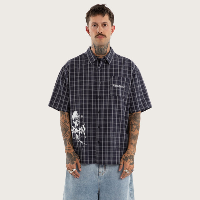 Model wears Graphite Skate Short Sleeve Shirt Graphite Check in Black - Image 1