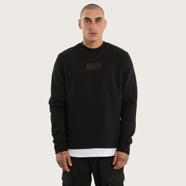 Model wears Apparition Layered Sweater Jet Black Jumpers in Black - Image 3