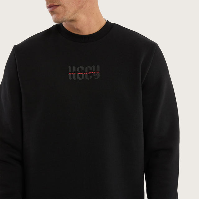 Model wears Apparition Layered Sweater Jet Black Jumpers in Black - Image 4