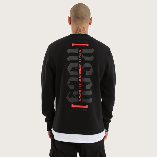 Model wears Apparition Layered Sweater Jet Black Jumpers in Black - Image 1