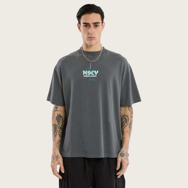 Model wears Archangel Box Fit Tee Pigment Grey T-Shirts in Grey - Image 1