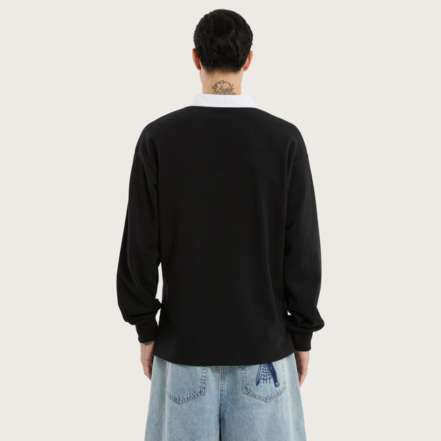 Model wears Stacked Rugby Jumper Jet Black Jumpers in Black - Image 3