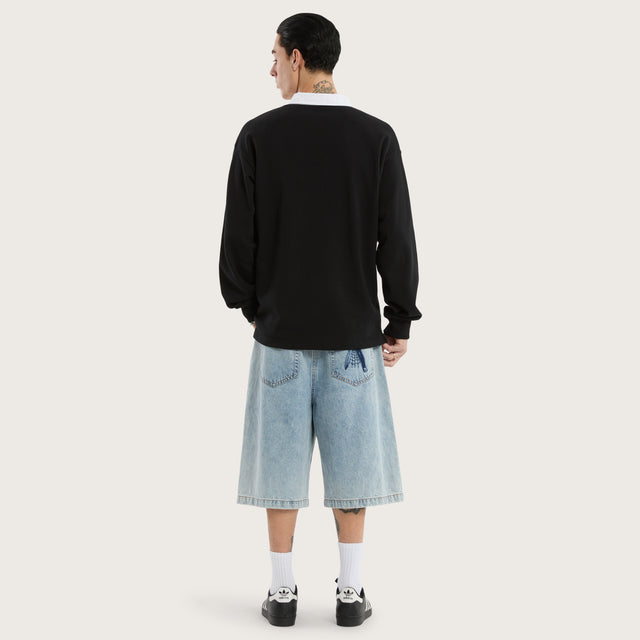 Model wears Stacked Rugby Jumper Jet Black Jumpers in Black - Image 4