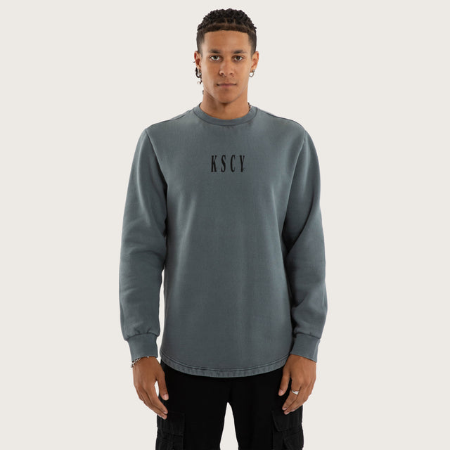 Model wears Rebellion Curved Hem Sweater in Blue Jumpers in Blue - Image 3