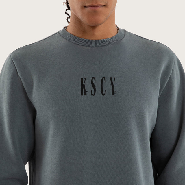 Model wears Rebellion Curved Hem Sweater in Blue Jumpers in Blue - Image 4