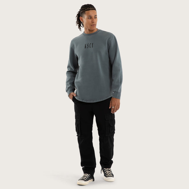 Model wears Rebellion Curved Hem Sweater in Blue Jumpers in Blue - Image 2