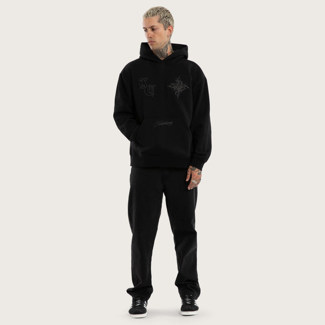 Model wears Paragons Relaxed Hoodie Jet Black Hoodies in Black - Image 5