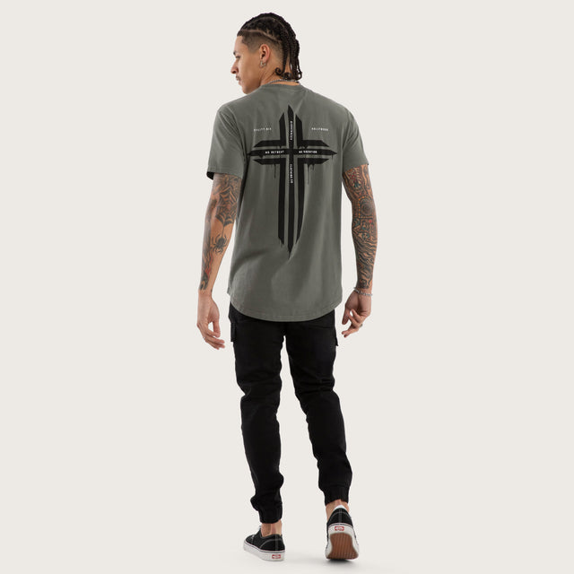 Model wears Preservation Curved Hem Tee in Green T-Shirts in Green - Image 4