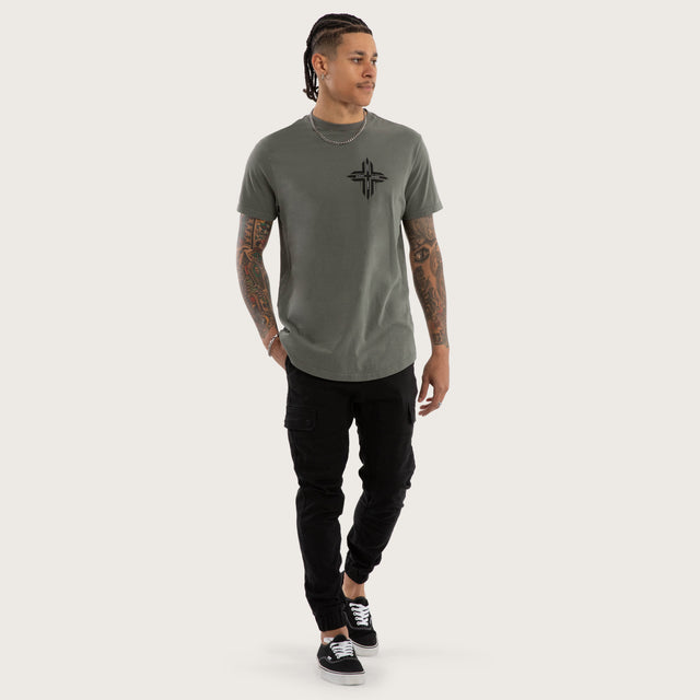 Model wears Preservation Curved Hem Tee in Green T-Shirts in Green - Image 5