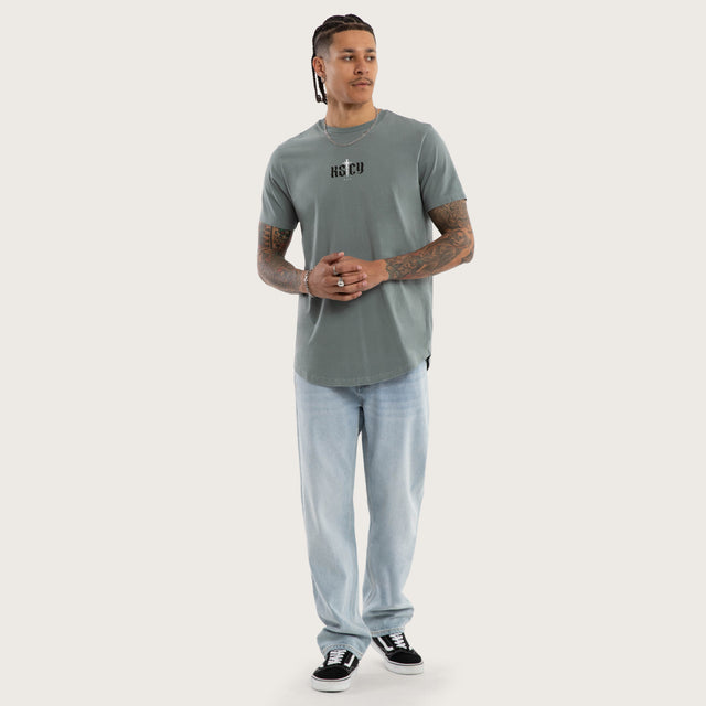 Model wears Exist Dual Curved Tee Pigment Stormy Sea T-Shirts in Blue - Image 5