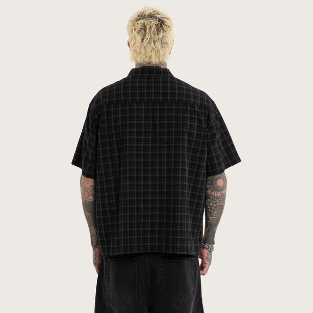 Model wears Luke Walker Phantom Button Up Short Sleeve Shirt Black Check Short Sleeve Shirts in Black - Image 3