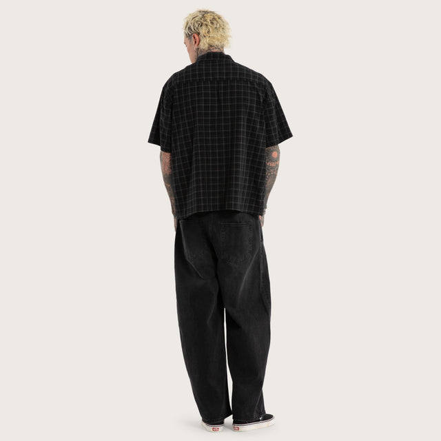 Model wears Luke Walker Phantom Button Up Short Sleeve Shirt Black Check Short Sleeve Shirts in Black - Image 4