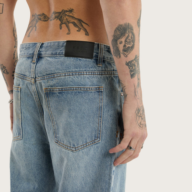 Model wears Wilder Bootcut Jean Baja Blue Pants in Blue - Image 7