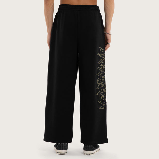 Model wears Wraith Baggy Sweatpant Jet Black Trackpants in Black - Image 5
