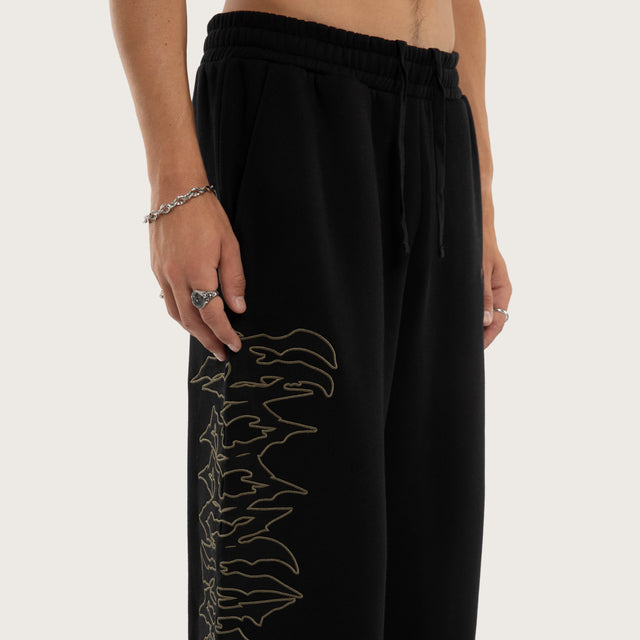 Model wears Wraith Baggy Sweatpant Jet Black Trackpants in Black - Image 6