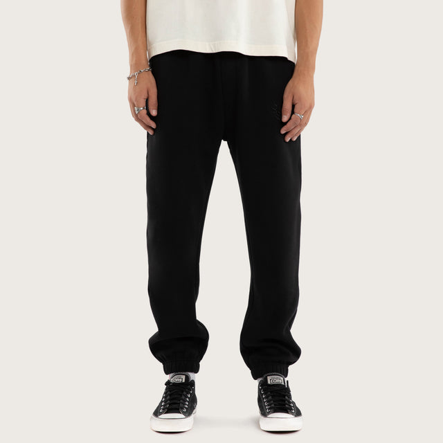 Model wears Frenzy Trackpant Jet Black Trackpants in Black - Image 3