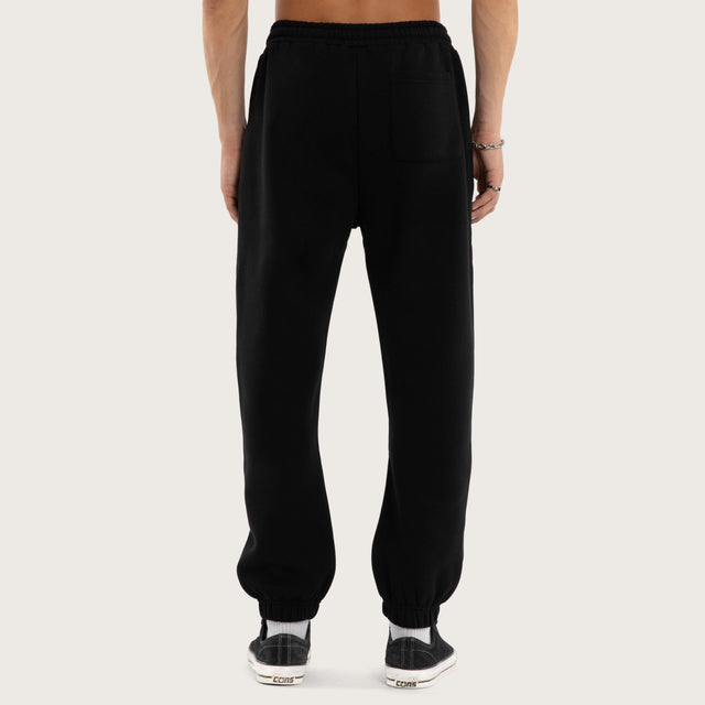 Model wears Frenzy Trackpant Jet Black Trackpants in Black - Image 5